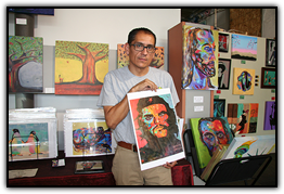Garcia shows a print of a painting of Che Guevara that he completed at the start of his recovery from cancer
